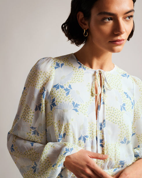 SUZIIEE-Dresses-Make every day a fashion show in SUZIIEE. Featuring our gorgeous poppy print and all the ruffles your heart desires, this versatile mini dress will take you from coffee mornings to dinner dates with ease.The fabric of this product is made with 30% recycled polyester. Using recycled polyester helps divert plastic waste from ending in landfills, and helps us to reduce our dependence on virgin materials. Mini dress Daisy print Long blouson sleeves Asymmetric ruffled hem Self tie neckline Zip fa